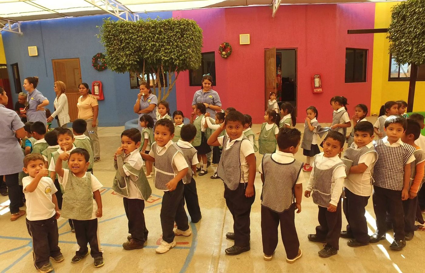 Schoolchildren gathered together in a colorful courtyard.